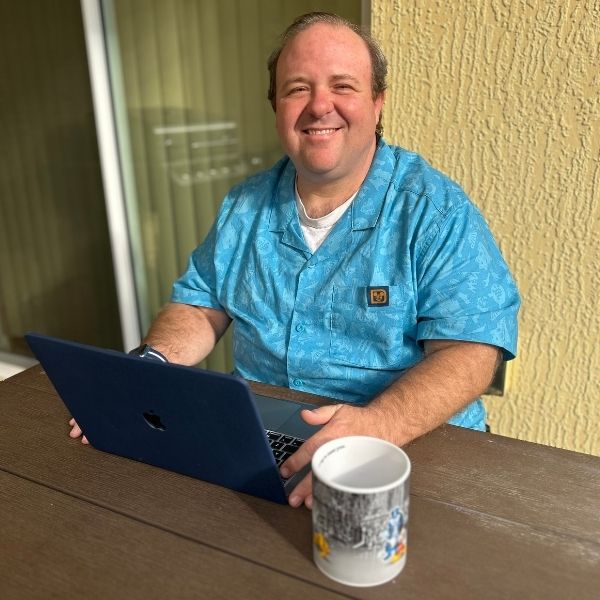 scott sitting at desk with laptop
